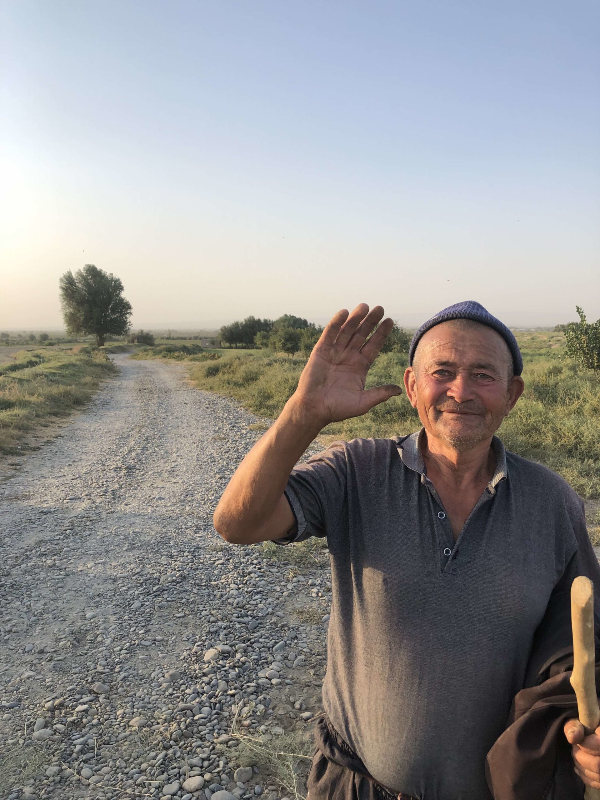 A photograph of a man waving on Matt Spencer’s cycling for sturgeon journey.