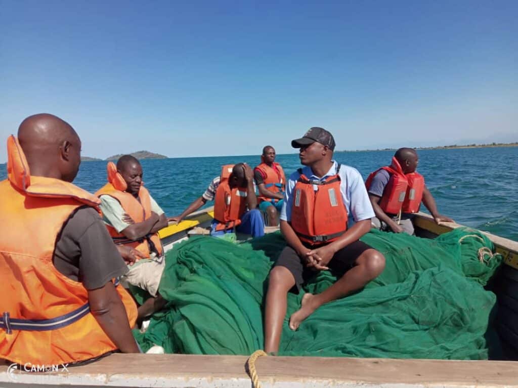 Fisheries and Beach Village Committee members with confiscted drag net © Ripple Africa